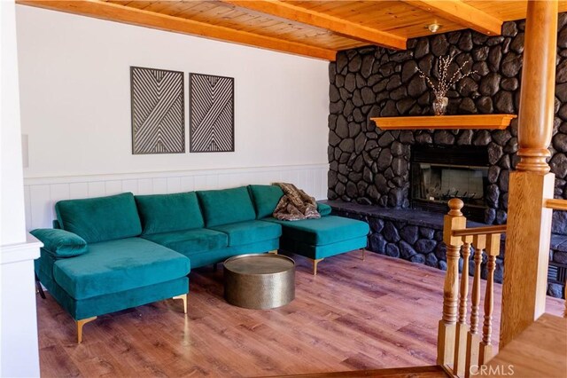 1075 Rivera Dr, Wrightwood, CA 92397 - living area featuring wooden ceiling, a fireplace, beam ceiling, and wood finished floors