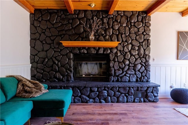 1075 Rivera Dr, Wrightwood, CA 92397 - living room with wainscoting, beamed ceiling, wooden ceiling, and a fireplace