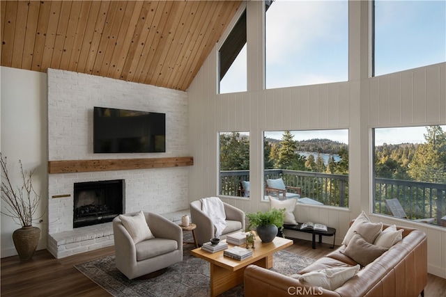 living area with high vaulted ceiling, wood ceiling, a brick fireplace, and wood finished floors