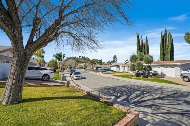 view of street featuring a residential view and curbs