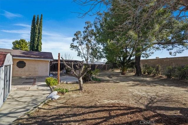 view of yard with a fenced backyard and a patio