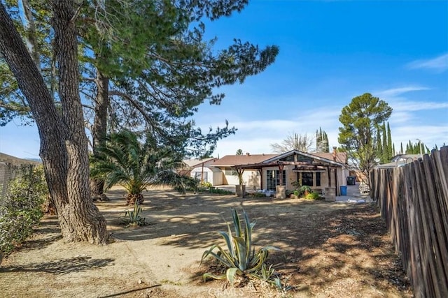 view of front of property featuring fence