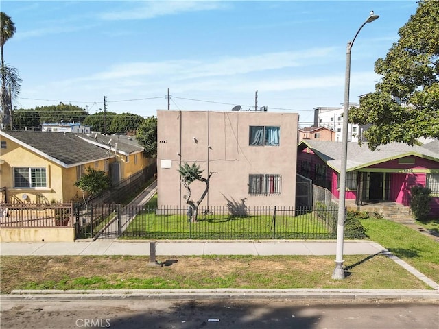 view of building exterior with a fenced front yard