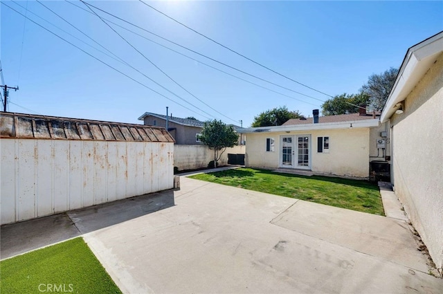 view of patio featuring fence and french doors