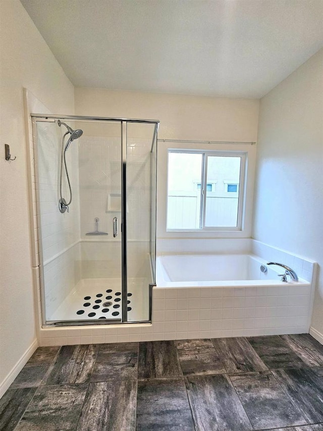 full bath with a bath and a shower stall