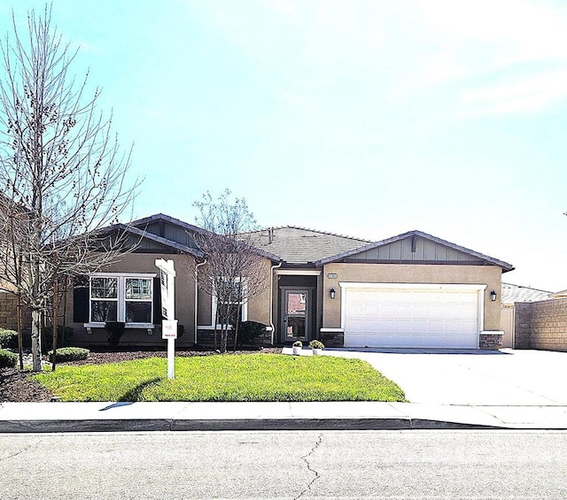 single story home with driveway, a garage, fence, a front lawn, and stucco siding