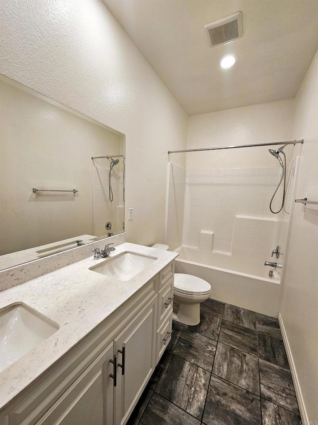 bathroom with washtub / shower combination, a sink, double vanity, toilet, and visible vents