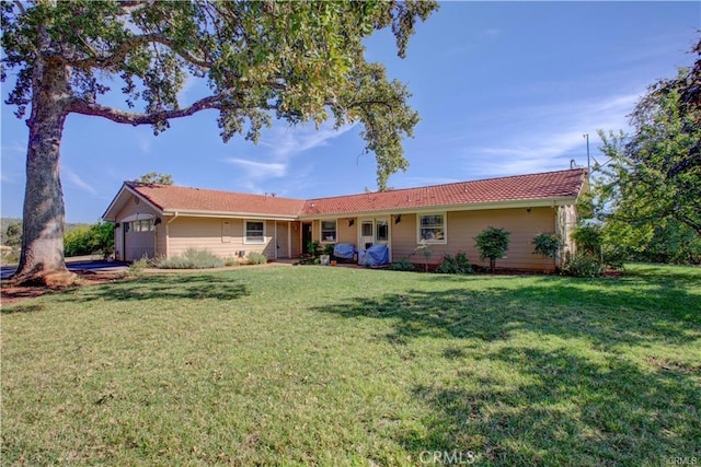 ranch-style home featuring a front yard