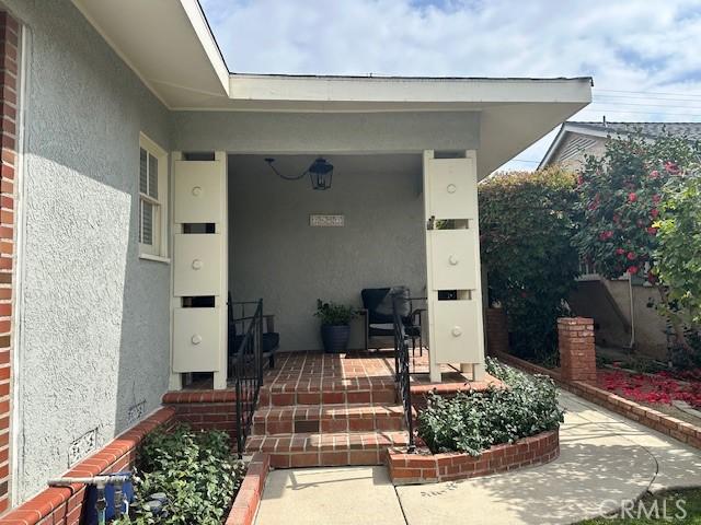 property entrance with stucco siding