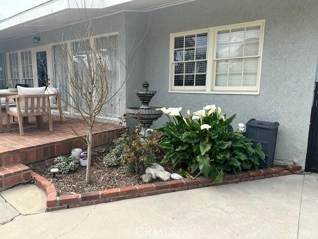 view of side of property with a patio area and stucco siding