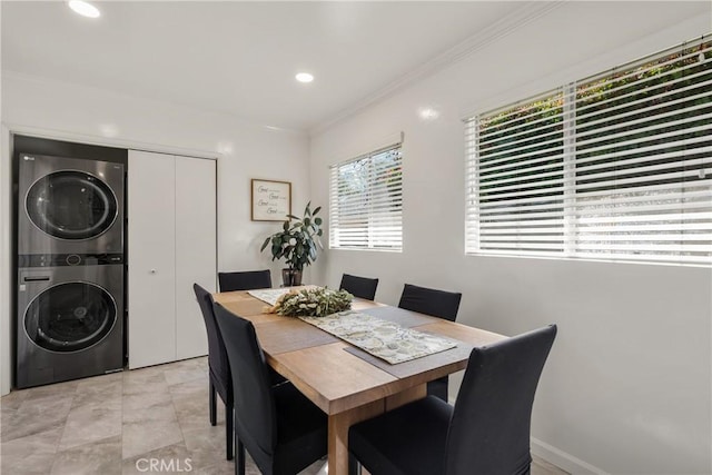 dining space with ornamental molding, recessed lighting, and stacked washing maching and dryer