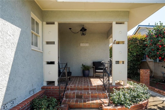 property entrance with stucco siding