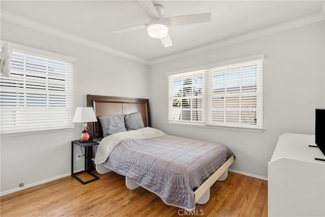 bedroom featuring light wood-type flooring, baseboards, a ceiling fan, and crown molding