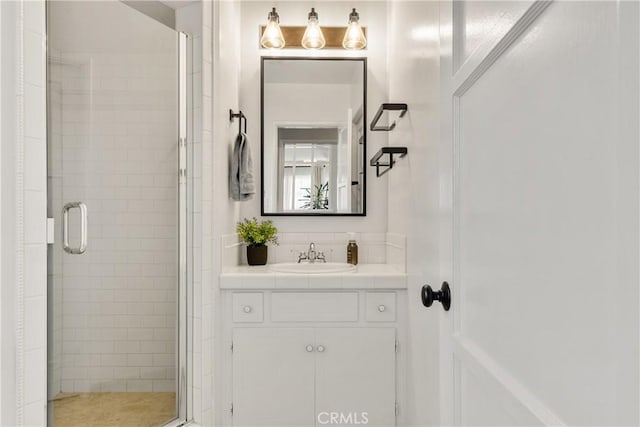 full bathroom featuring a stall shower and vanity