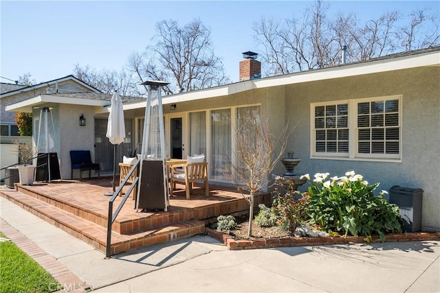 wooden terrace with a patio