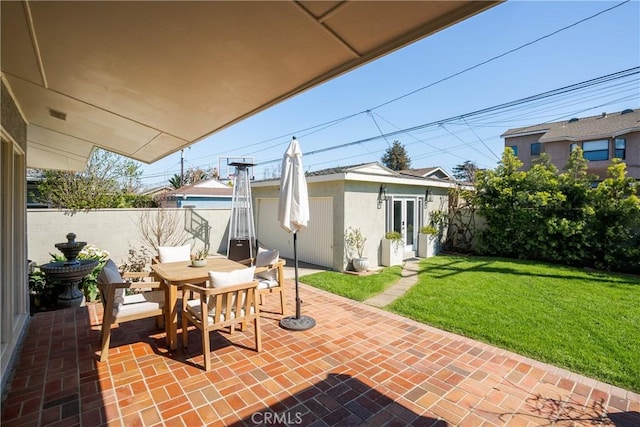 view of patio with an outbuilding, french doors, and fence