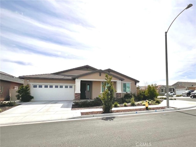 craftsman house featuring concrete driveway, an attached garage, and stucco siding