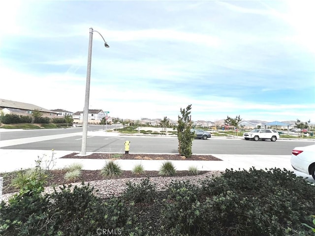 view of road with sidewalks and street lighting