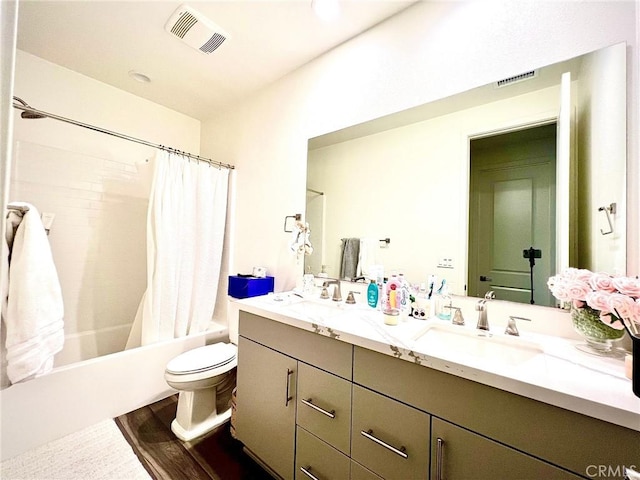 full bathroom with toilet, visible vents, and a sink