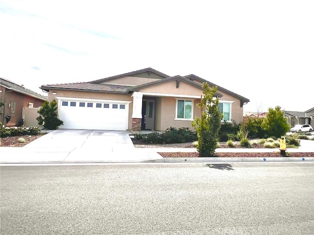 view of front of property with a garage, driveway, and stucco siding