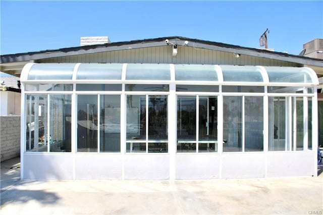 view of side of property featuring a sunroom