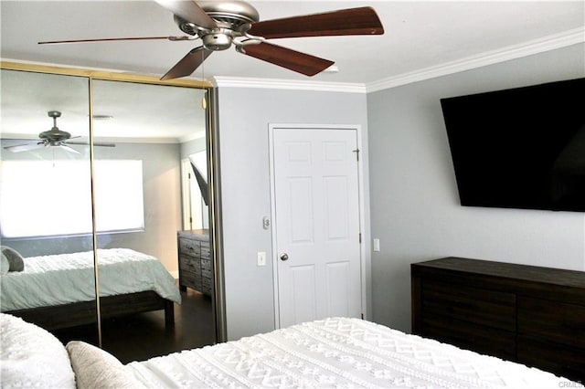 bedroom featuring a ceiling fan, a closet, and crown molding