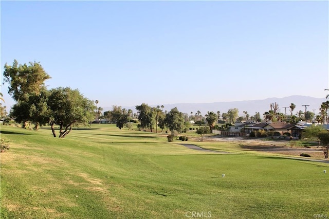 view of property's community with a lawn and golf course view