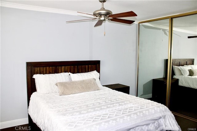 bedroom featuring ceiling fan, baseboards, a closet, and ornamental molding