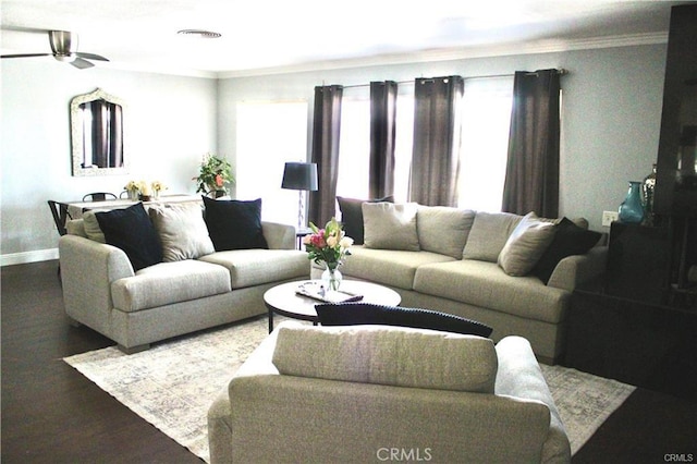 living room featuring a healthy amount of sunlight, visible vents, and wood finished floors