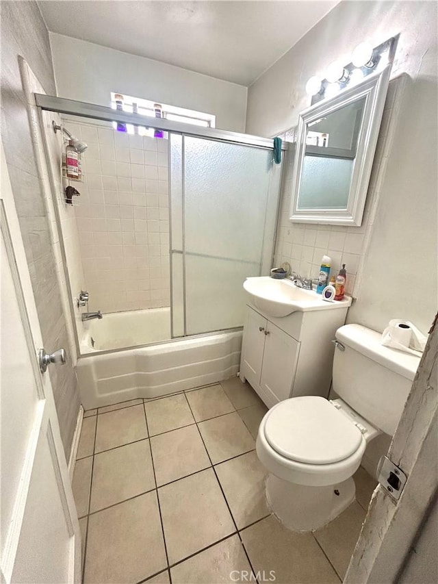 full bathroom featuring enclosed tub / shower combo, toilet, vanity, tile patterned floors, and tasteful backsplash