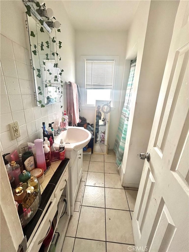 bathroom featuring curtained shower, vanity, decorative backsplash, and tile patterned floors