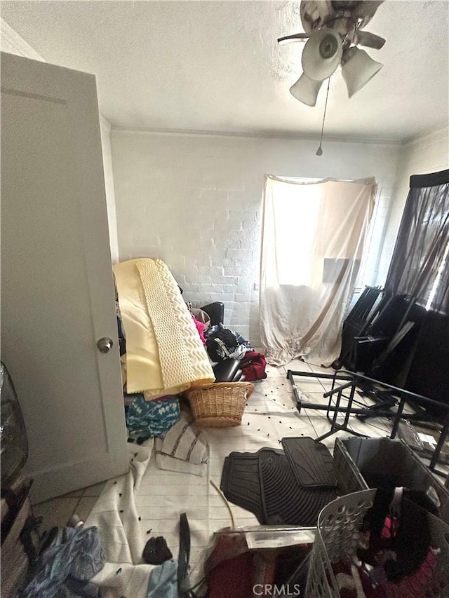 miscellaneous room featuring a textured ceiling and a ceiling fan