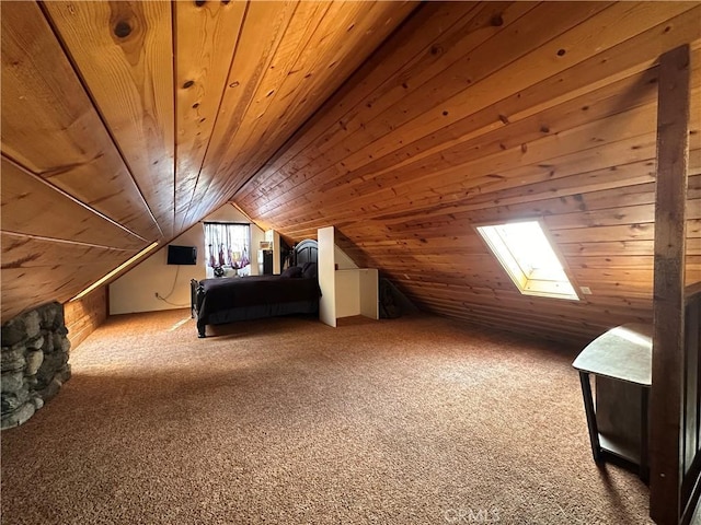 unfurnished bedroom featuring carpet floors, wooden ceiling, and vaulted ceiling with skylight