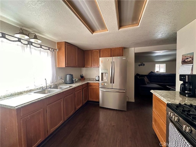 kitchen with dark wood-style flooring, light countertops, a sink, and stainless steel refrigerator with ice dispenser