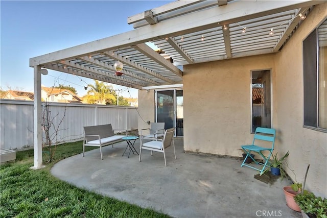 view of patio with a pergola and fence