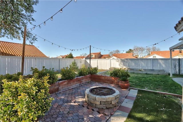 exterior space with a fire pit and a fenced backyard