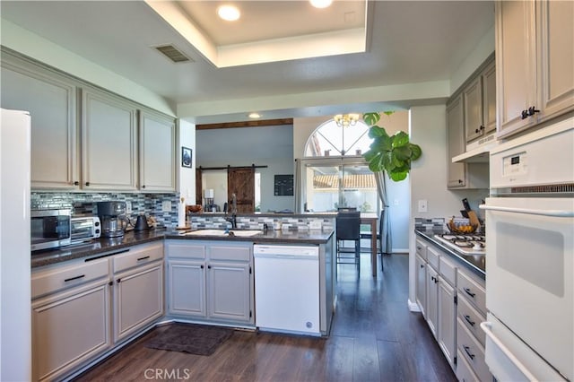 kitchen featuring a sink, dark countertops, visible vents, and stainless steel appliances