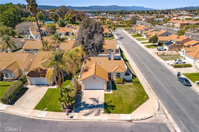 birds eye view of property with a mountain view and a residential view