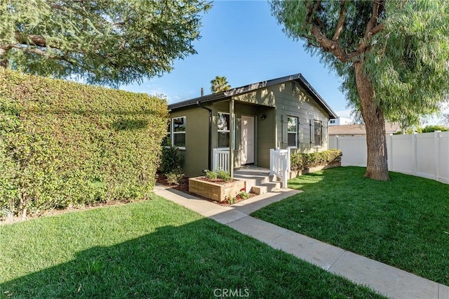 exterior space featuring a yard and fence