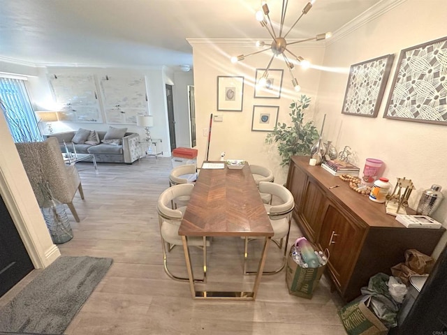 dining room with an inviting chandelier, light wood-style flooring, and ornamental molding