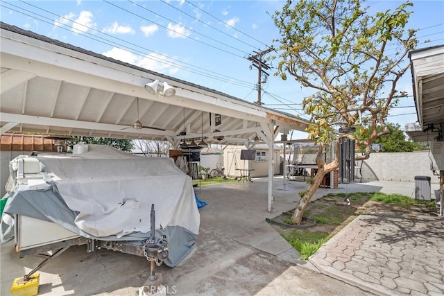 view of patio / terrace featuring grilling area, a carport, and fence