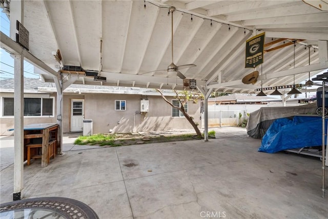 view of patio featuring a ceiling fan and fence