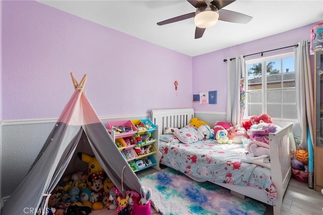 bedroom with wood finished floors and a ceiling fan