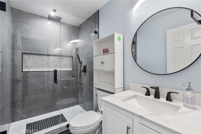 full bath with vanity, toilet, and tiled shower