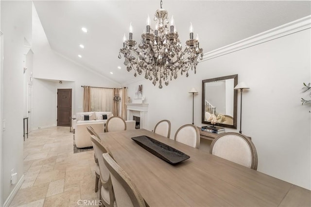 dining room featuring stone tile floors, crown molding, a fireplace, a notable chandelier, and recessed lighting