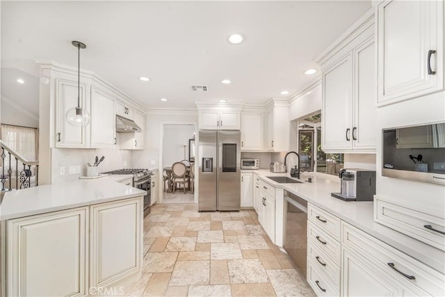 kitchen featuring under cabinet range hood, stainless steel appliances, a sink, light countertops, and ornamental molding