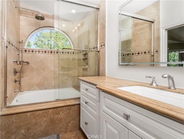 full bathroom with tiled shower / bath and vanity