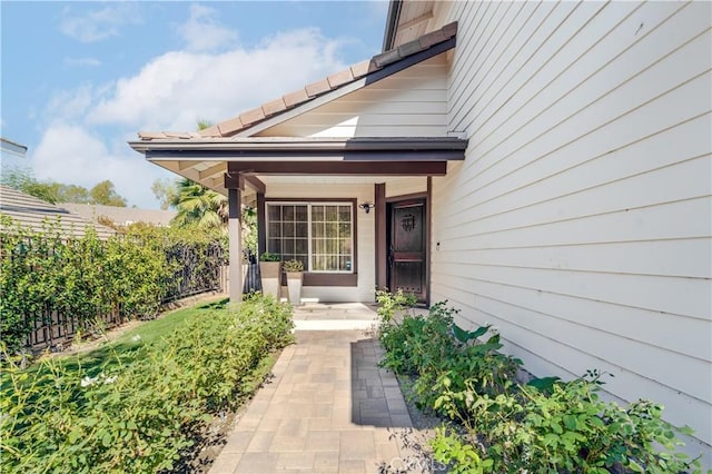 doorway to property featuring fence