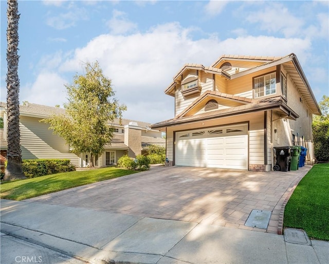 traditional-style house with a front lawn, decorative driveway, and an attached garage