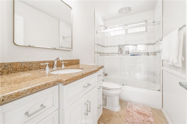 full bathroom featuring combined bath / shower with glass door, vanity, toilet, and tile patterned floors